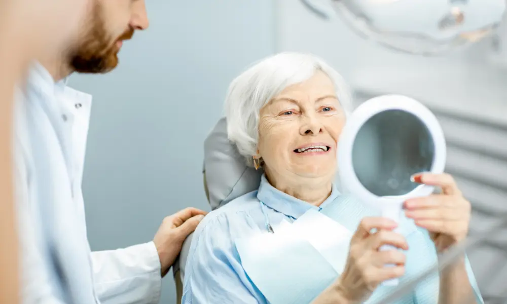 Senior patient reviewing dental results with dentist during dental visit and insurance-covered care