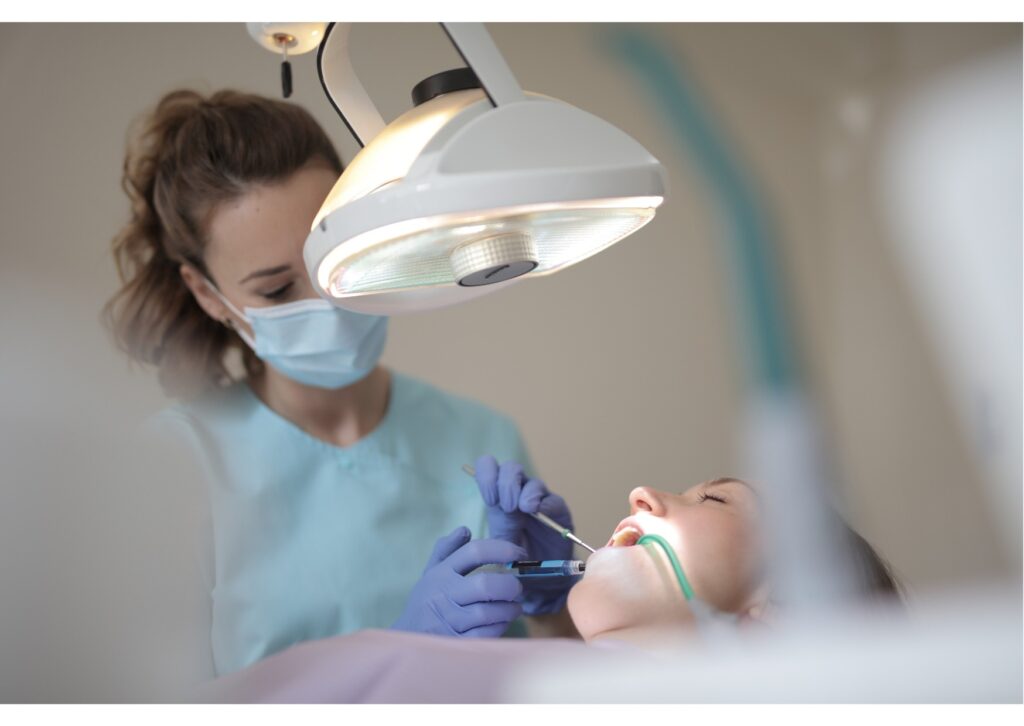 Dentist treating a patient during a dental implant consultation and restorative dental procedure