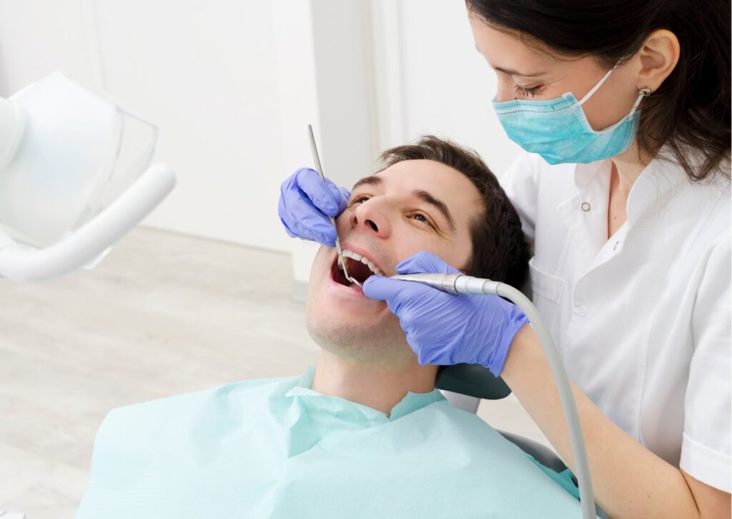 Dentist examining a patient’s tooth to diagnose a cracked tooth that may cause pain when biting, chewing, or releasing pressure.