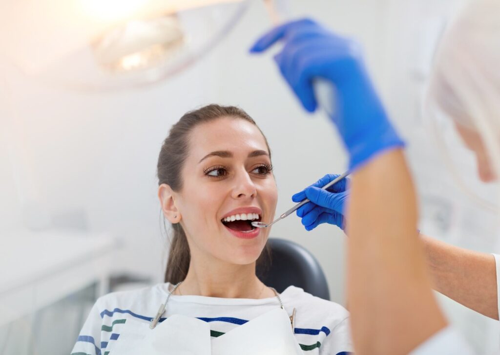 Dentist discussing treatment options with a patient during a consultation about the difference between crowns and veneers.