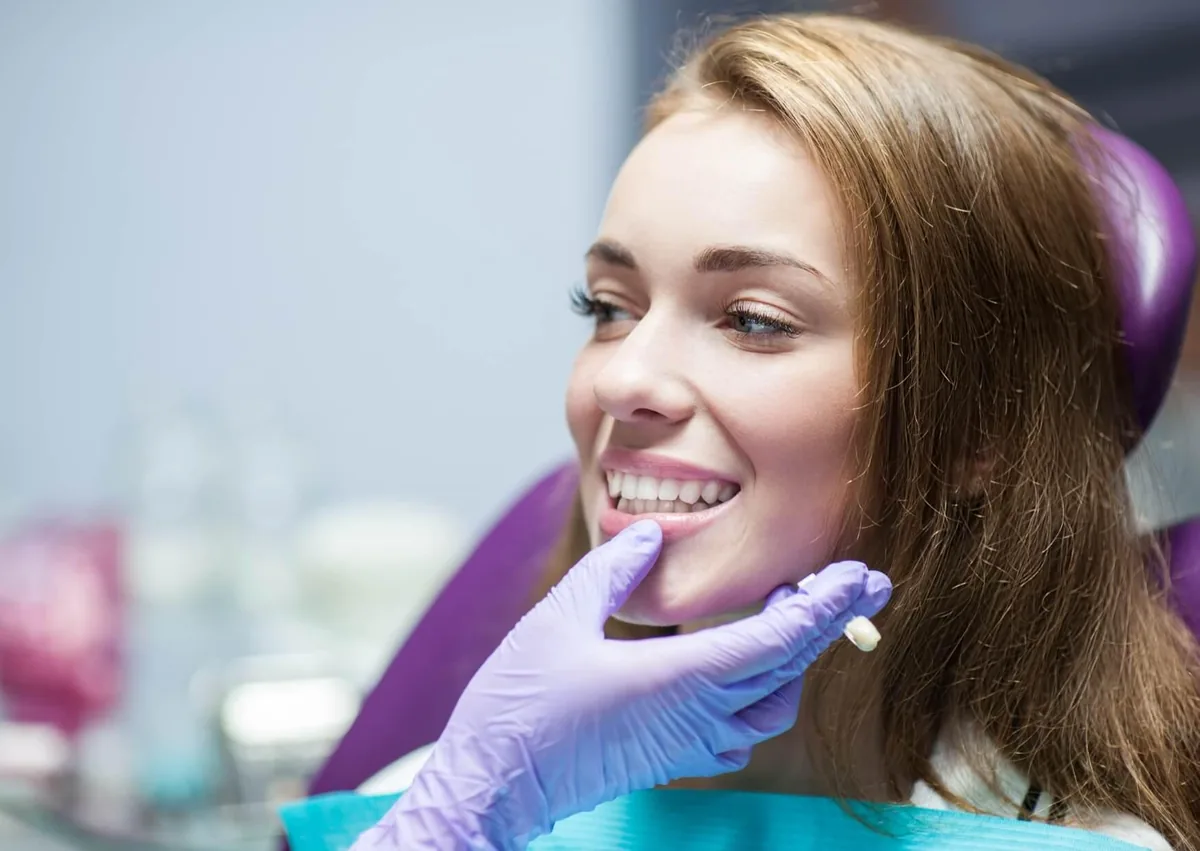 Patient discussing cosmetic dentistry options and treatment costs during a dental consultation.