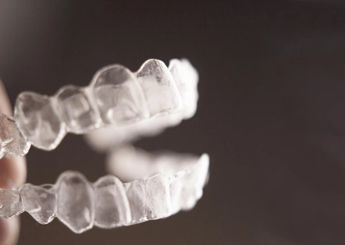 Clear upper and lower dental retainers showing removable options that can affect retainers cost.