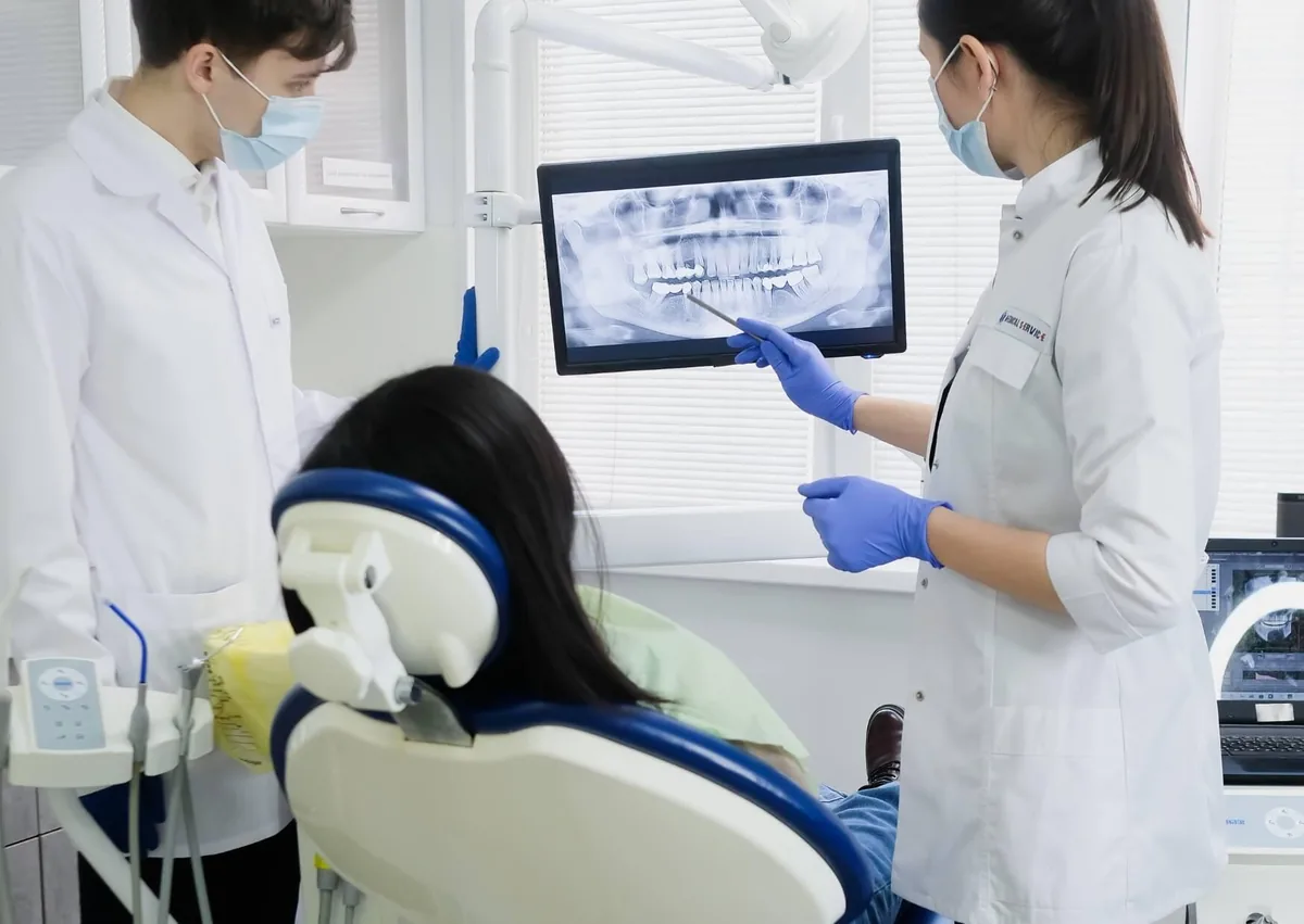 Dental team reviewing a patient’s X-ray while planning affordable dental implant treatment.